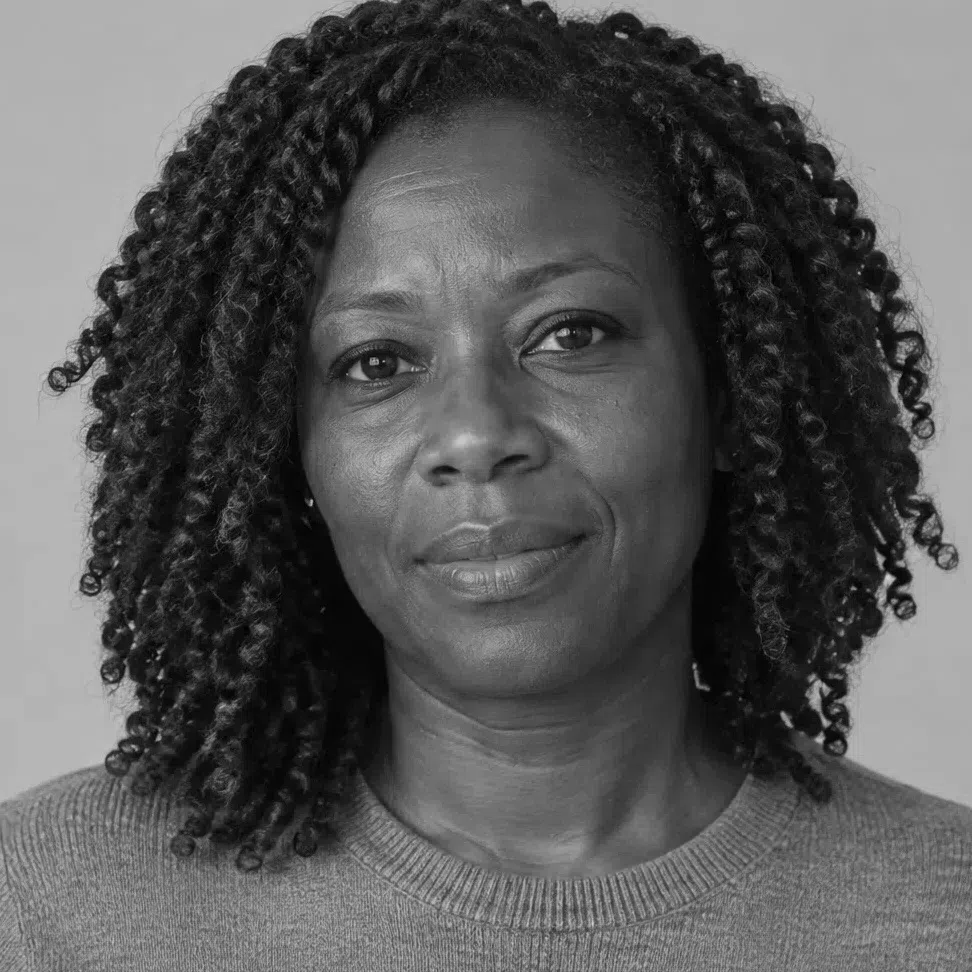 A Deep Autumn with deep brown skin and the hue removed, her twists a clear step darker than her cheek