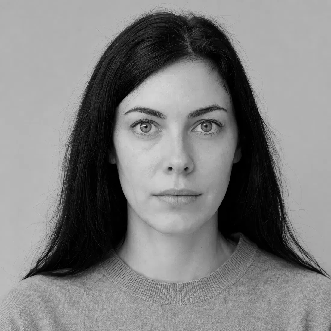Grayscale portrait of a Deep Winter woman, black hair framing pale skin