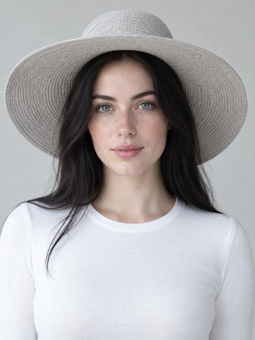 A wide-brim hat on a Bright Winter with near-black hair, tinted to one jewel shade after another above a gray or white knit