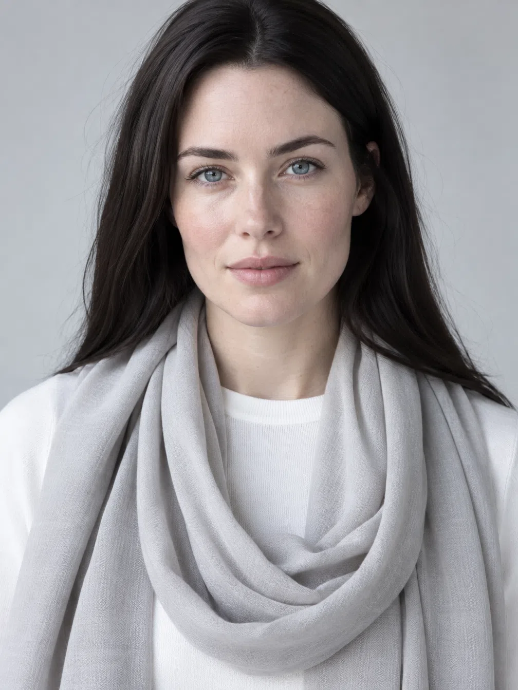 A dark-haired Bright Winter in a plain white knit, her silk scarf recolored in Ruby