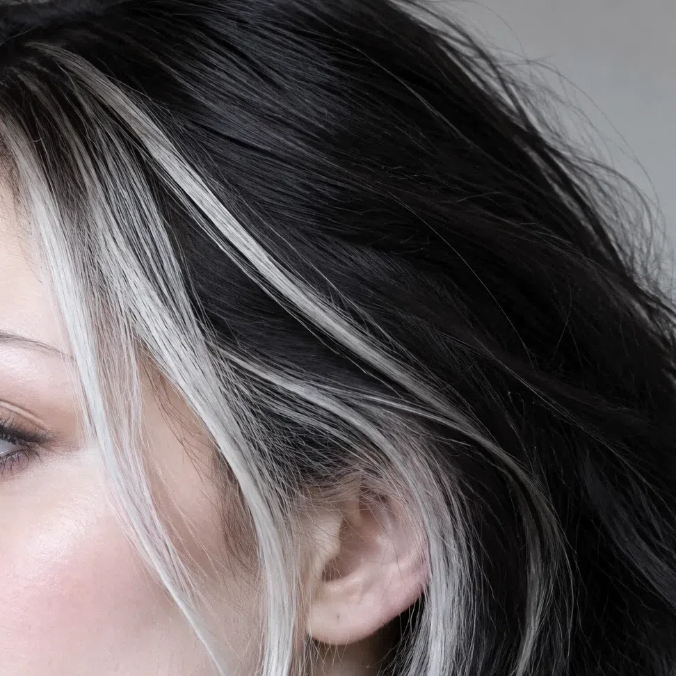 Platinum streaks worked into dark hair on a Bright Winter