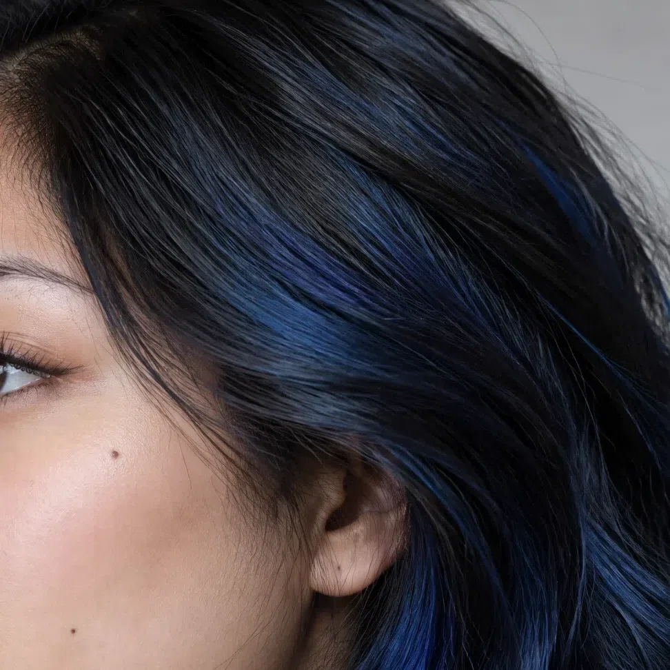Sapphire lights worked into dark hair on a Bright Winter