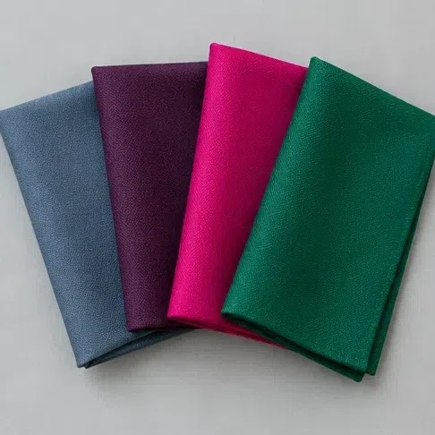 Fabric swatches fanned from a smoky blue-gray to an electric magenta and a vivid green
