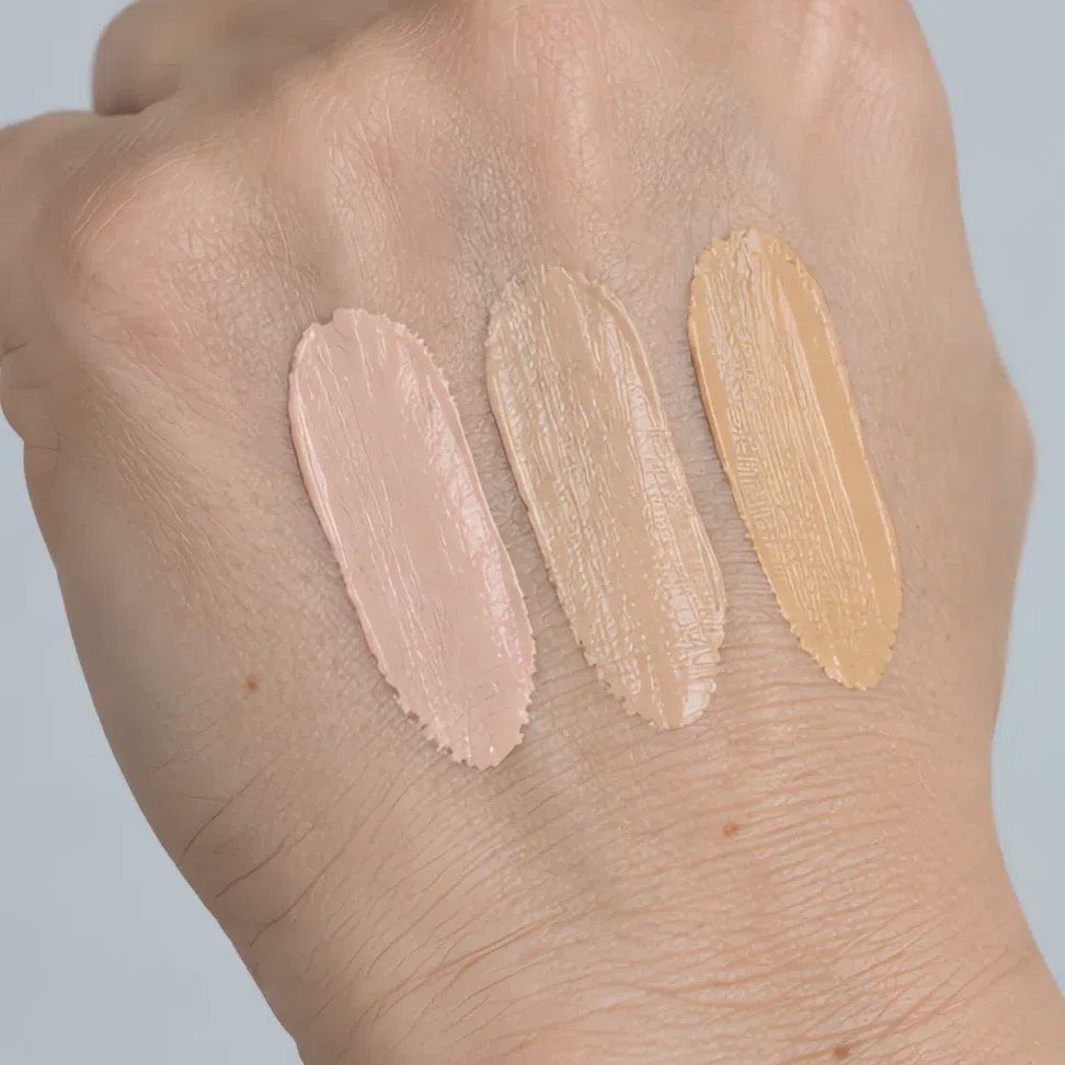The same three shades swatched on the back of a hand, all of them plausible there