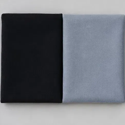 Folded cold black cloth next to a folded dove gray-blue cloth