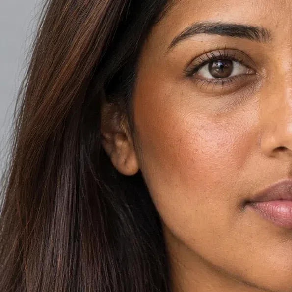 Close crop of medium golden skin sculpted with a cinnamon-toned bronzer