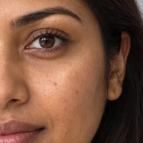 Apricot highlighter picking up the light on medium skin