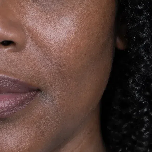 Deep espresso-brown Deep Winter cheek skin with a cool plum-red depth
