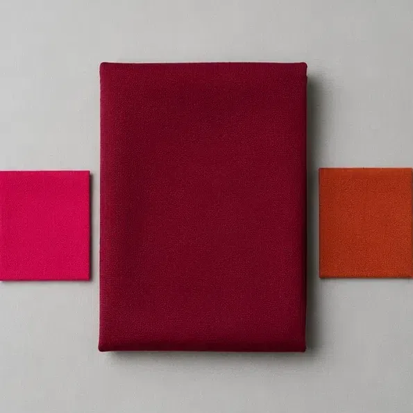 Deep burgundy fabric between a fuchsia swatch and a rust swatch