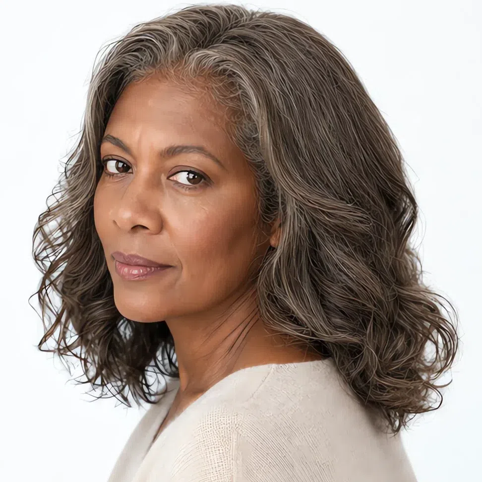 A Light Summer woman with deep brown skin and blended gray hair