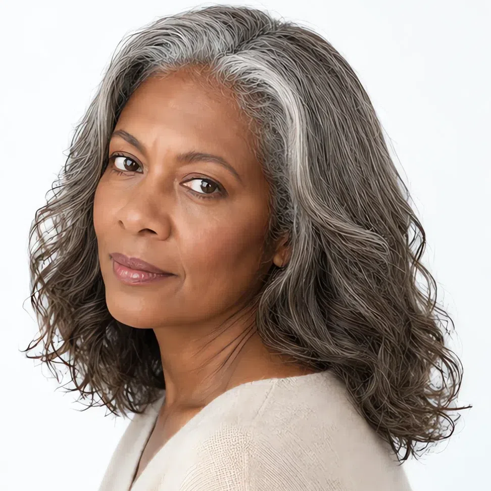 A Light Summer woman with deep brown skin and growing-out gray hair