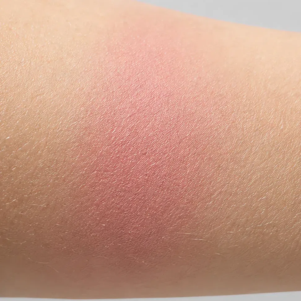 The same blush swatched and blended on the forearm in soft daylight