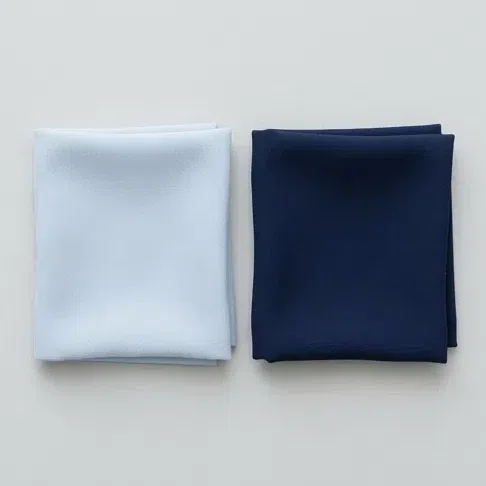 A pale powder blue fabric square beside a deep navy one