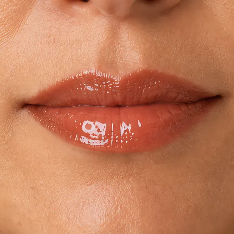 The same lipstick in a high-gloss finish with a hard specular highlight