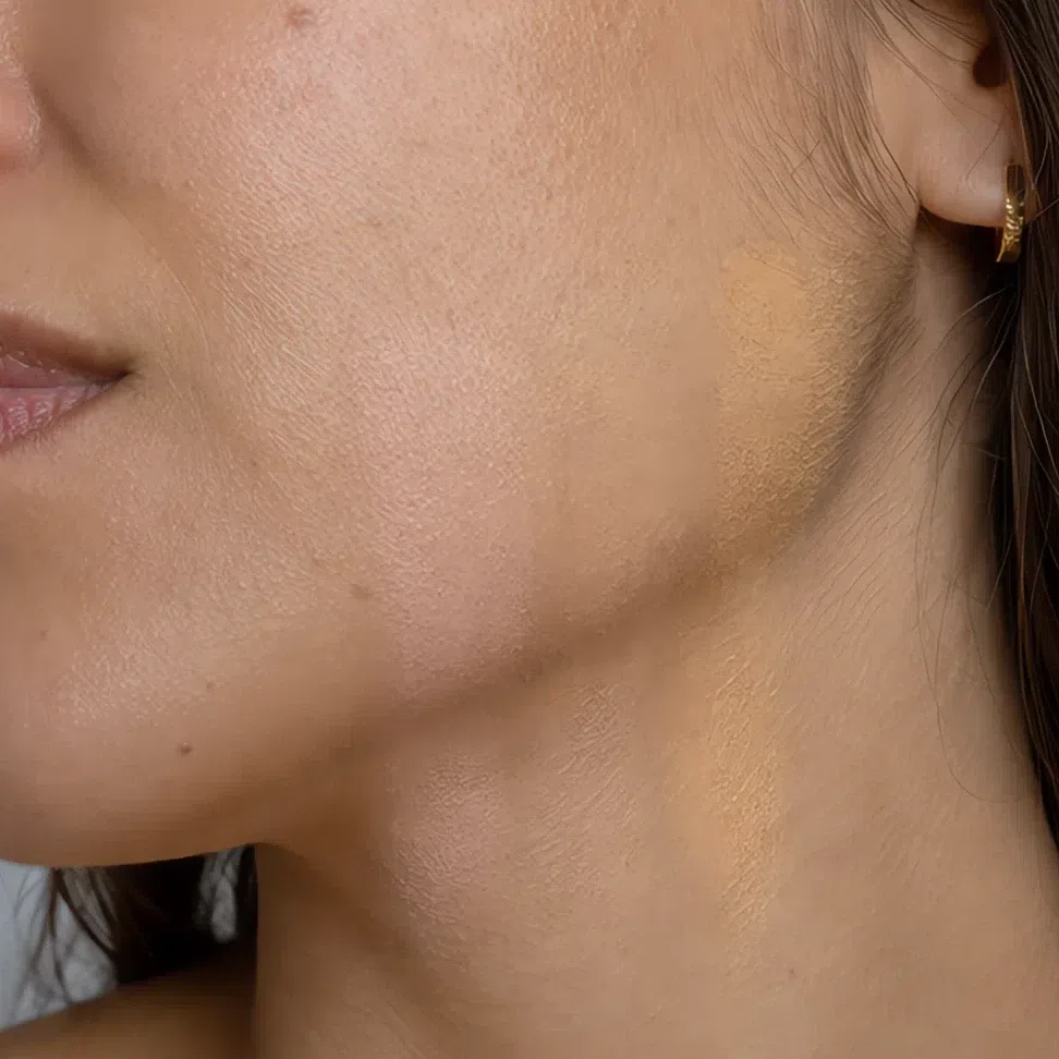 Three blended foundation stripes across the jaw, the middle one invisible and the outer two still showing