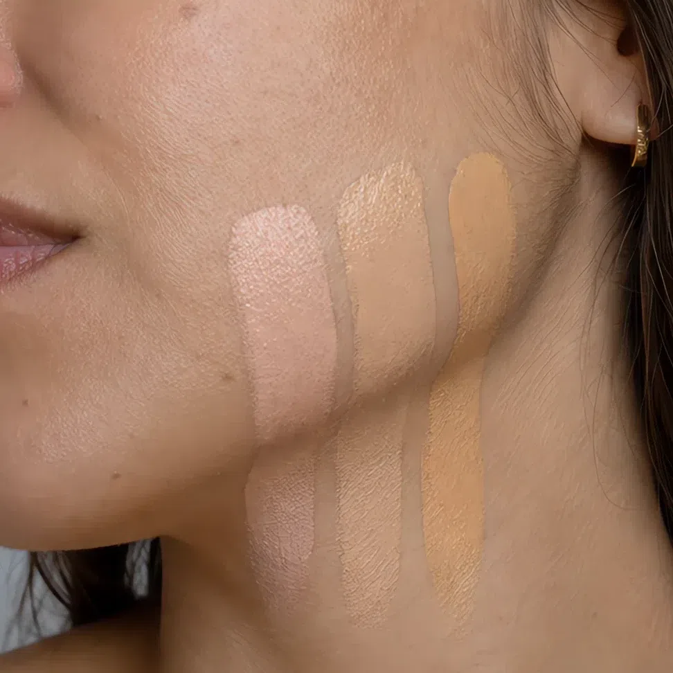 Three unblended foundation stripes across the jawline