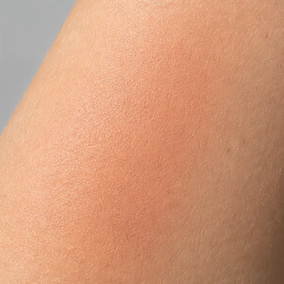 The same blush swatched and blended on the forearm in soft daylight