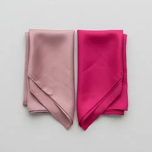 A dusty rose scarf beside a bright fuchsia one