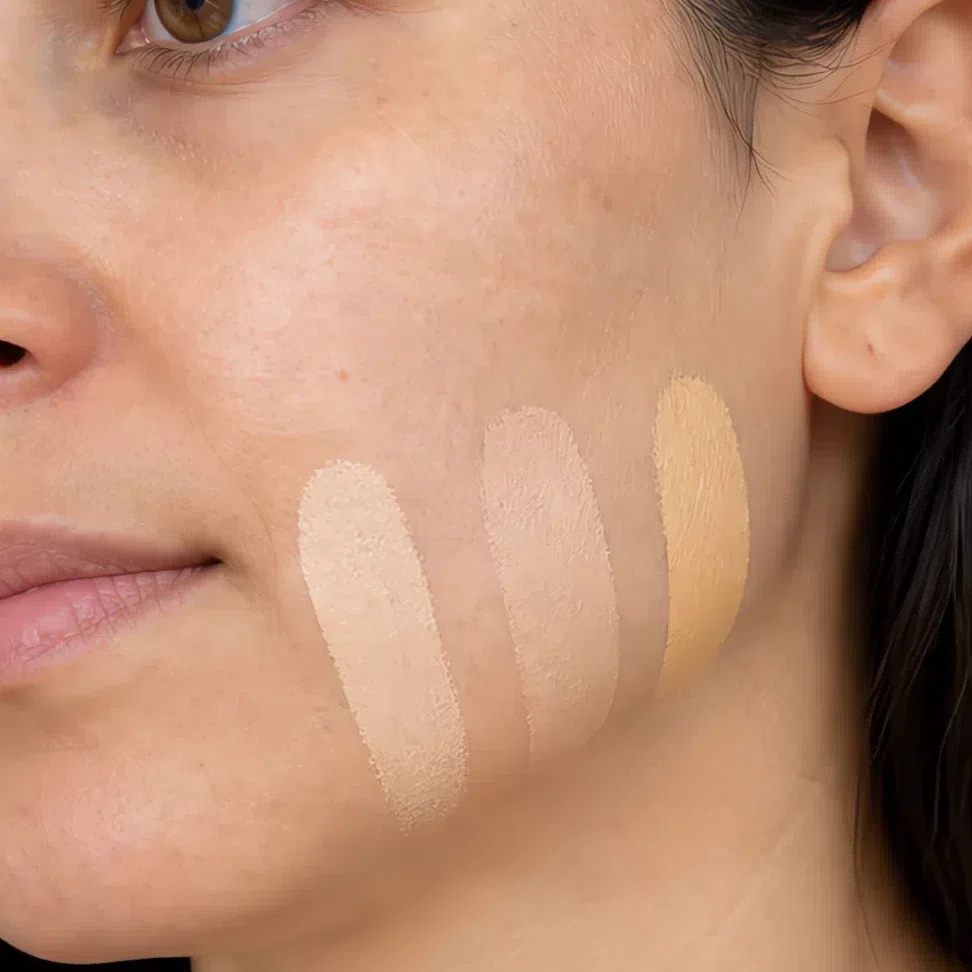 Three unblended foundation stripes across the jawline