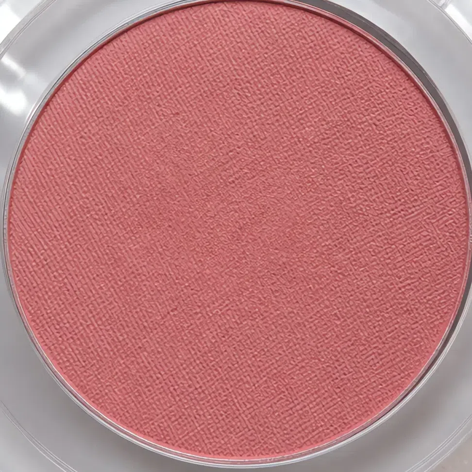 The same dusty rose blush photographed in its pan, looking more saturated