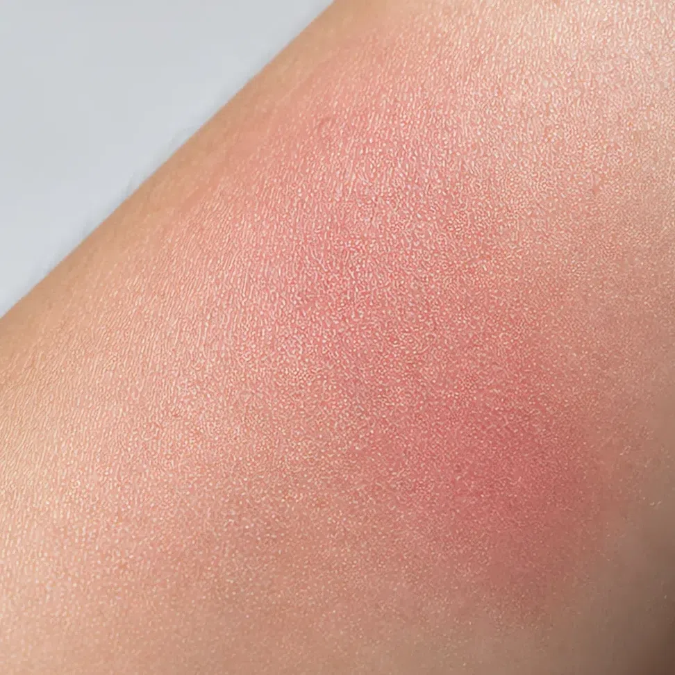 The same blush swatched and blended on the forearm in soft daylight