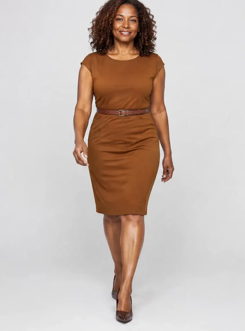 A deep-complexion Warm Autumn woman in a burnt-orange sheath dress with a thin belt