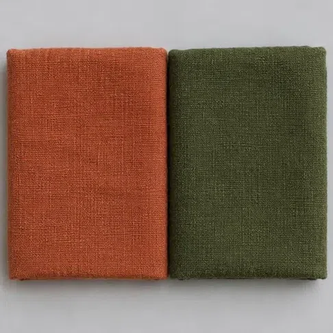 Terracotta and moss-green linen squares laid side by side