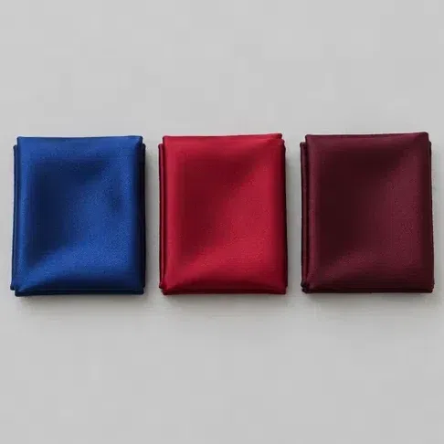 Folded silk in clear sapphire, ruby red and deep burgundy, laid side by side