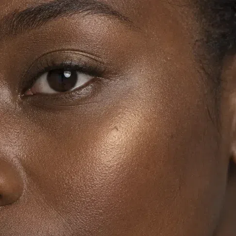 Copper gold highlighter on a deep Warm Spring complexion