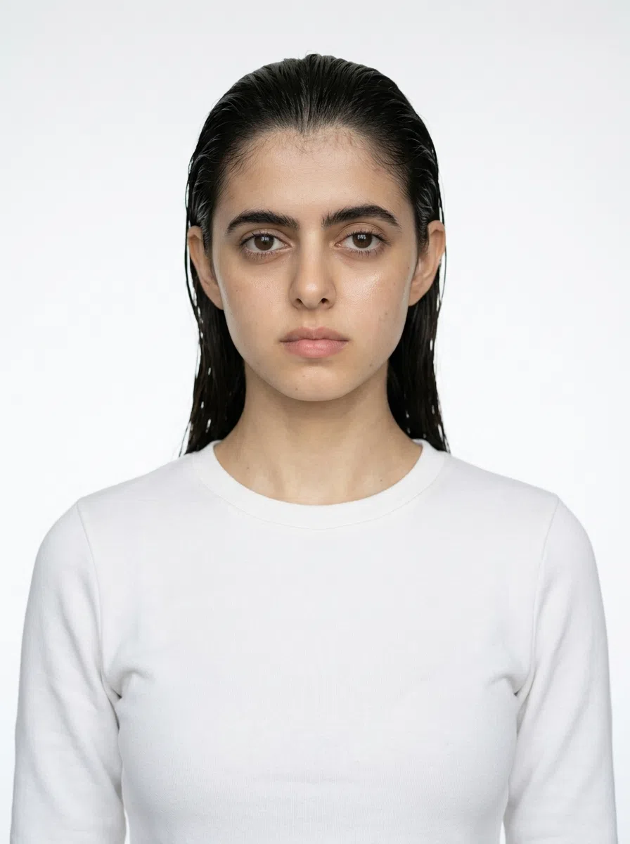 A Deep Autumn model - light olive skin, near-black warm brown hair, white crew-neck