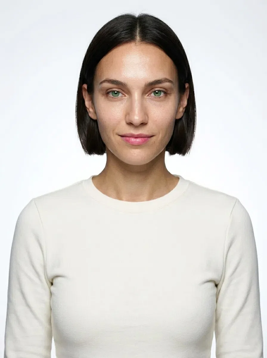 A Bright Winter model with a dark brown bob and green-hazel eyes, wearing a plain top that takes on each color as you tap it