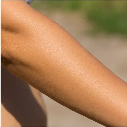 Skin that tans evenly to a golden tone - warm coloring